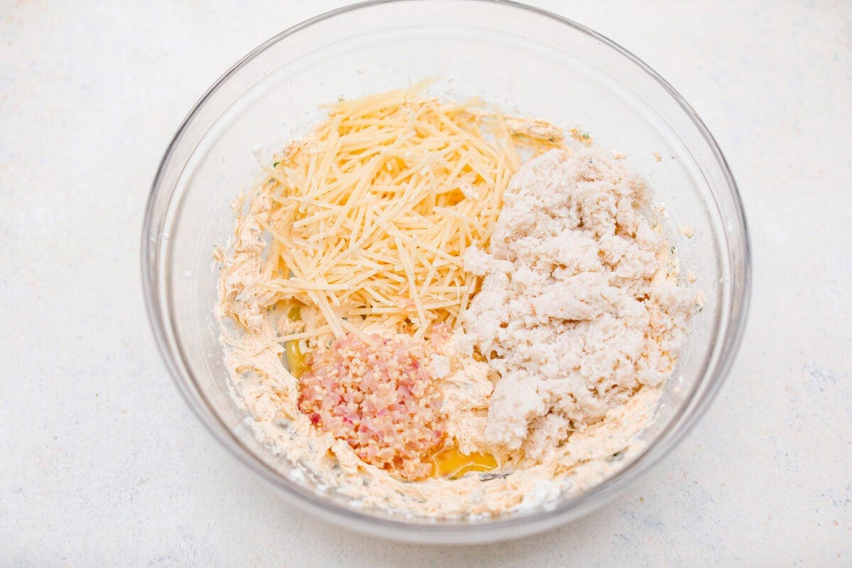 Overhead shot of the cream cheese mixture with cheese, crab meat, garlic and shallot mixture.