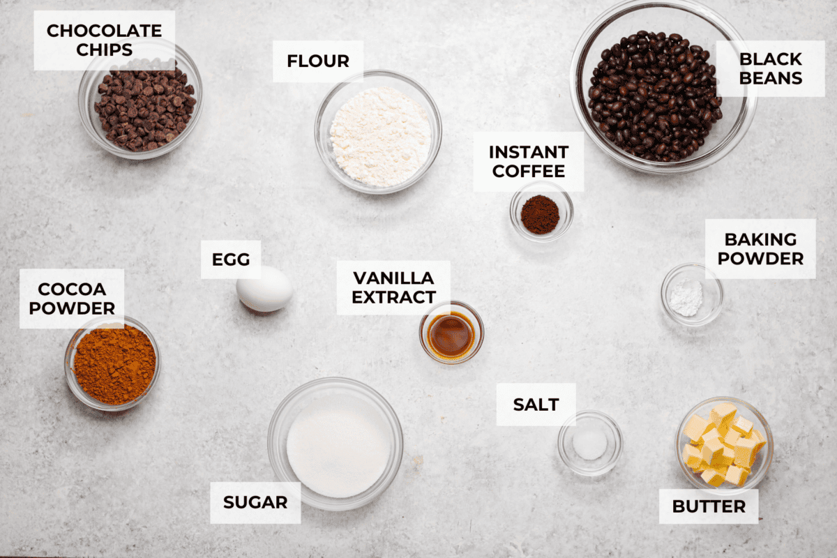 Black bean brownies are rich, fudgy, and packed with chocolatey goodness! They have a slightly denser texture, similar to a protein bar, but still satisfy that brownie craving. While adults may notice a slight difference from traditional brownies, kids wonโt be able to tell! Overhead shot of labeled ingredients.