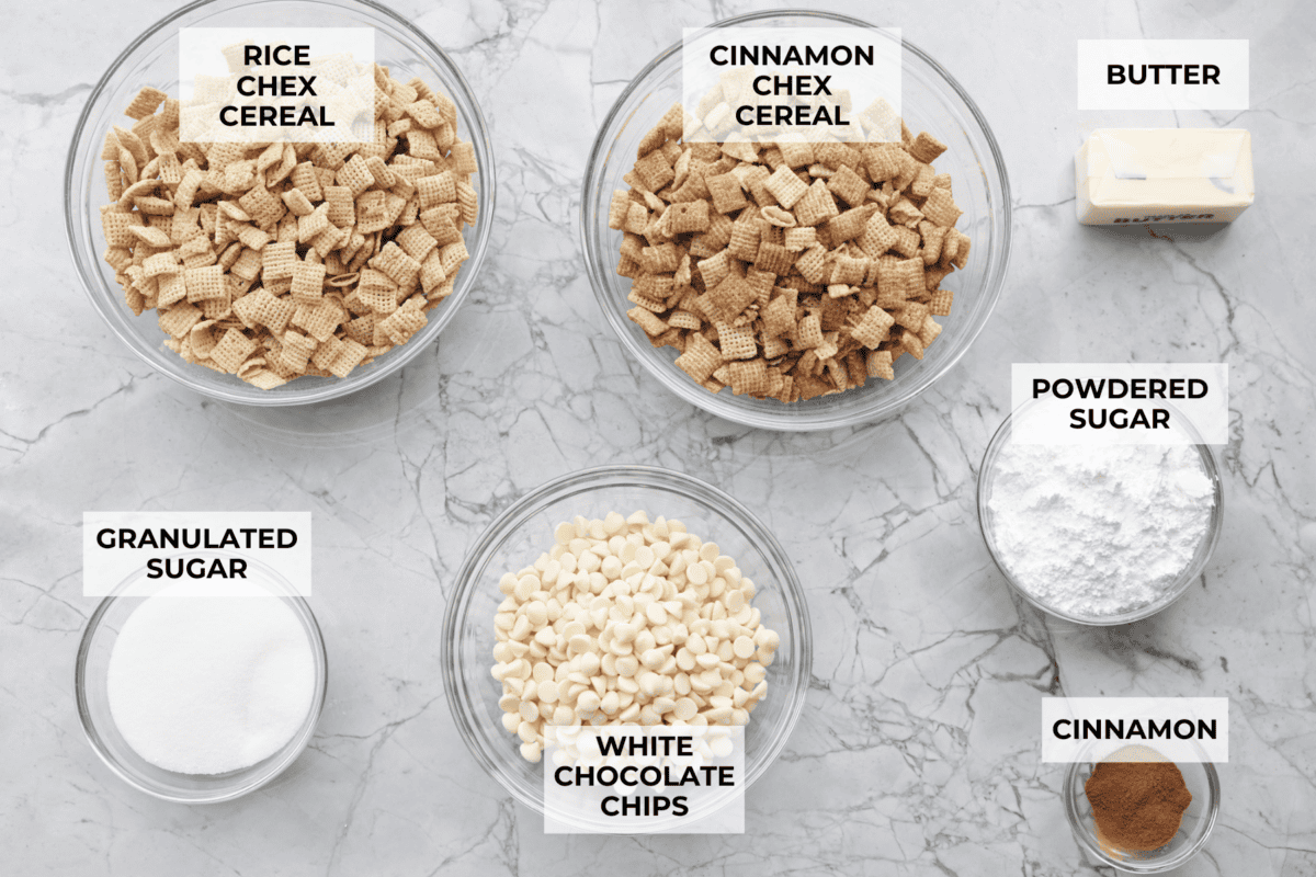 Churro Chex Mix is a fun variation of the popular muddy buddy mix. Sweet cinnamon and sugar mixed with silky white chocolate coat the crunchy cereal to create an addicting treat. It's the perfect snack to whip up for game day, road trips, or weeknights when that sweet tooth hits! Overhead shot of labeled ingredients.