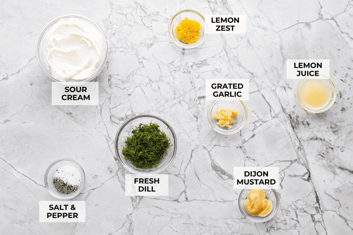 This creamy dill sauce is fresh, tangy, and packed with flavor! Itโs the perfect complement to salmon, roasted veggies, or even as a dip for crispy potatoes. Made with simple ingredients like fresh dill, lemon, and a touch of garlic, it comes together in minutes! Overhead shot of labeled ingredients.