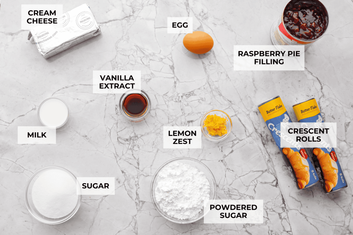 This Raspberry Cream Cheese Crescent Ring is a simple pastry with a flaky, golden crust, a sweet and tangy cream cheese filling, and a burst of raspberry flavor. Perfect for breakfast, brunch, or dessert, it's easy to make yet impressively delicious! Overhead shot of labeled ingredients.