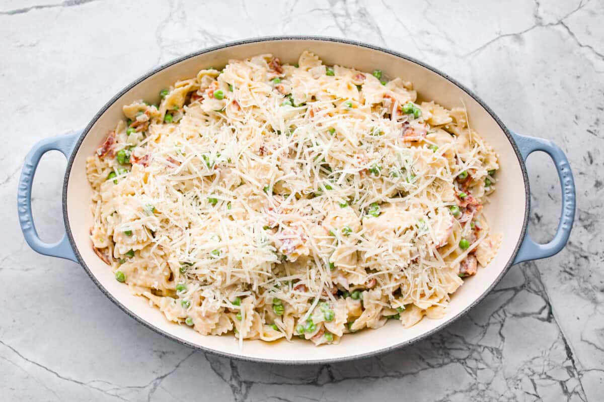 Stanley Tucci pasta casserole is everything you want in a casserole. It's simple to make and incredibly flavorful! TikTok is going crazy over the crispy bacon, tender peas, and the creamy, cheesy sauce that holds everything together! Overhead shot of all of the ingredients in a baking dish.