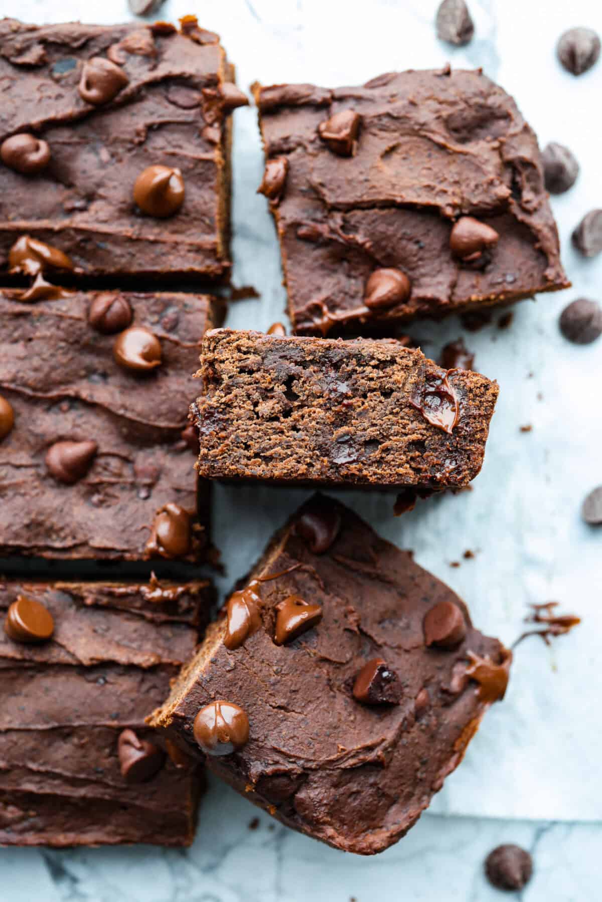 Black bean brownies are rich, fudgy, and packed with chocolatey goodness! They have a slightly denser texture, similar to a protein bar, but still satisfy that brownie craving. While adults may notice a slight difference from traditional brownies, kids wonโt be able to tell! Close up shot of black bean brownies.