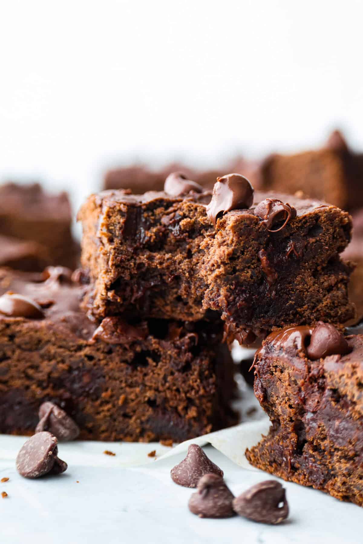 Black bean brownies are rich, fudgy, and packed with chocolatey goodness! They have a slightly denser texture, similar to a protein bar, but still satisfy that brownie craving. While adults may notice a slight difference from traditional brownies, kids wonโt be able to tell! Close up shot of a black bean brownie with a bite taken out of it.