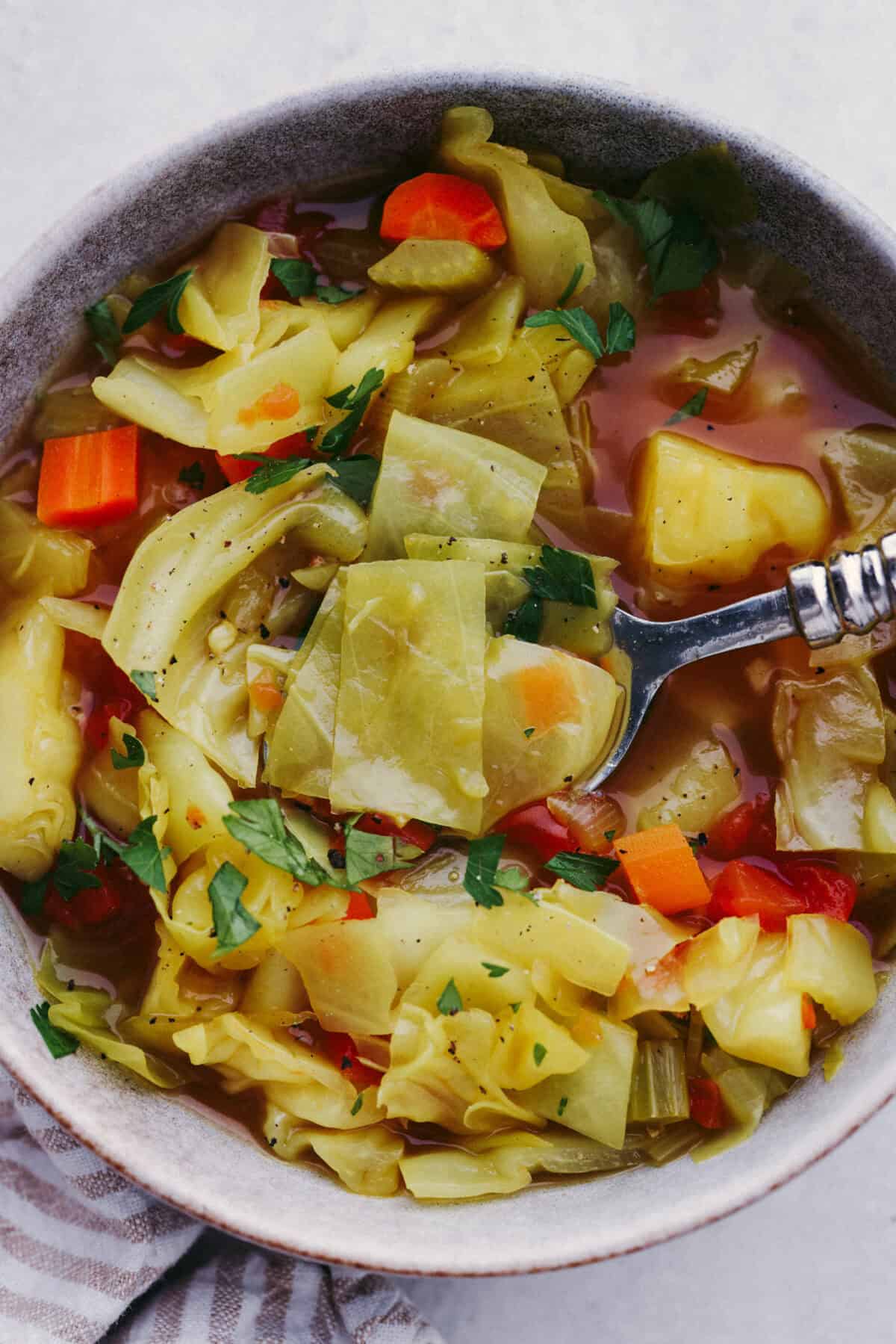 This Detox Cabbage Soup is the perfect way to kick off your New Year's resolutions! After indulging over the holidays, this soup will give you the kick-start you need to feel better. It's loaded with fresh veggies and essential vitamins and is super budget-friendly.