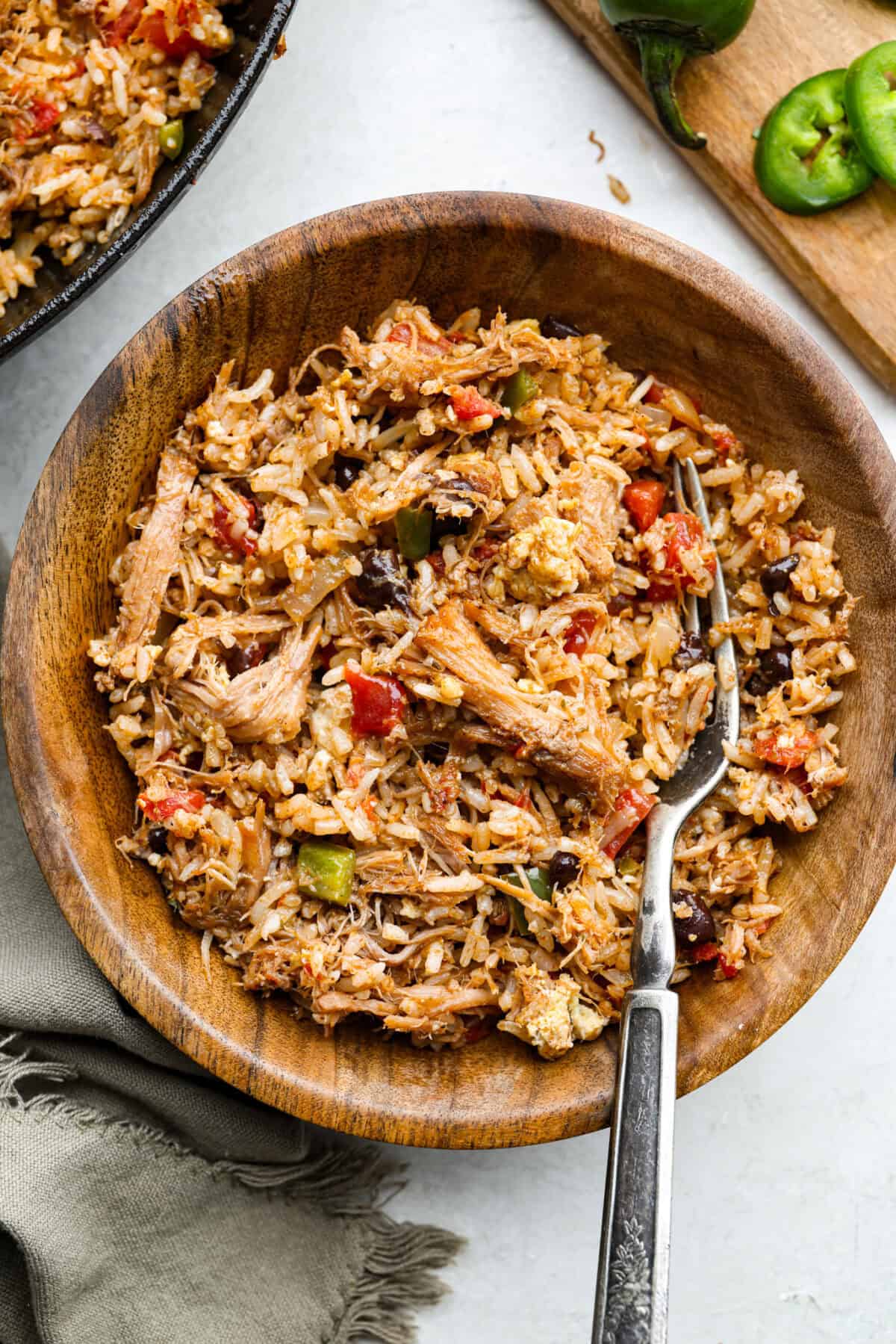 Cowboy Fried Rice is a Tex-Mex twist on the classic! It's loaded with bold spices and hearty ingredients like pulled pork, black beans, and diced tomatoes. Made in one skillet and ready in just 30 minutes, itโs the perfect quick and satisfying meal for busy nights. Overhead shot of plated cowboy fried rice.