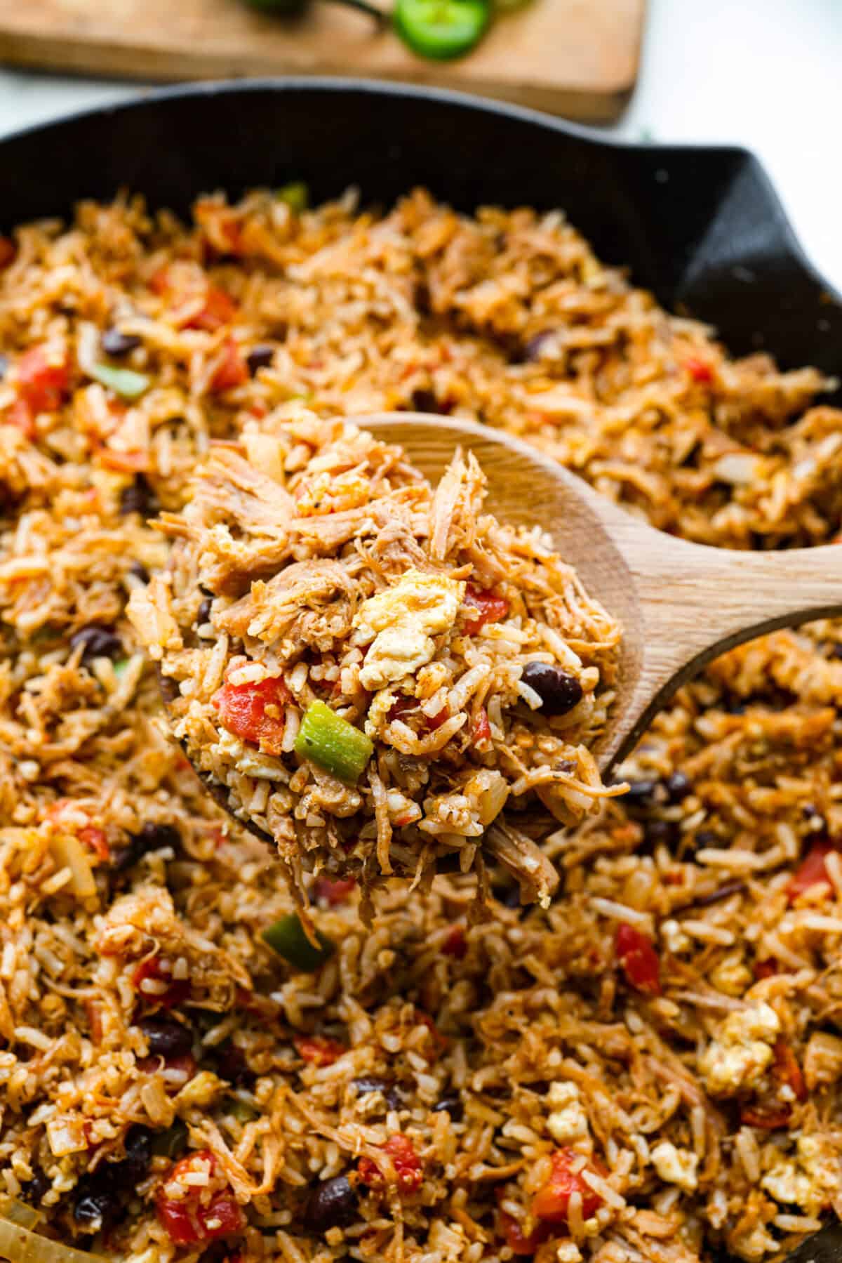 Cowboy Fried Rice is a Tex-Mex twist on the classic! It's loaded with bold spices and hearty ingredients like pulled pork, black beans, and diced tomatoes. Made in one skillet and ready in just 30 minutes, itโs the perfect quick and satisfying meal for busy nights. Close up shot of cowboy fried rice.