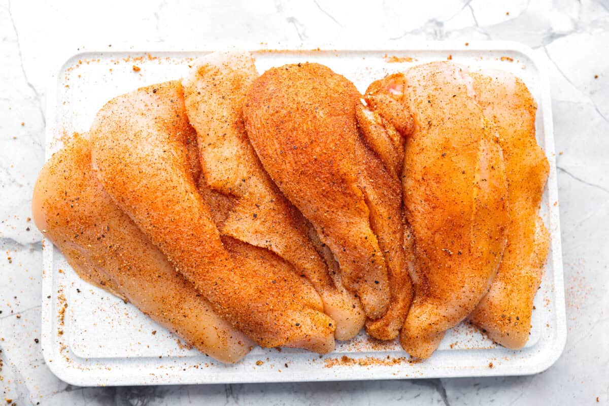 Creamy Cajun Chicken is the perfect combination of bold, zesty flavors and rich, velvety sauce. Juicy, tender chicken is coated in a perfectly spiced Cajun seasoning and simmered in a luscious, creamy sauce thatโs packed with flavor. Overhead shot of chicken cutlets covered in seasoning.