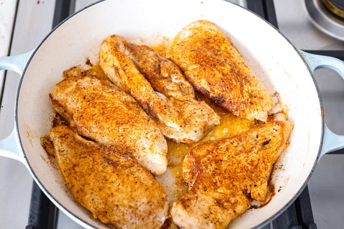 Creamy Cajun Chicken is the perfect combination of bold, zesty flavors and rich, velvety sauce. Juicy, tender chicken is coated in a perfectly spiced Cajun seasoning and simmered in a luscious, creamy sauce thatโs packed with flavor. Overhead shot of seasoned chicken cooking in a skillet.
