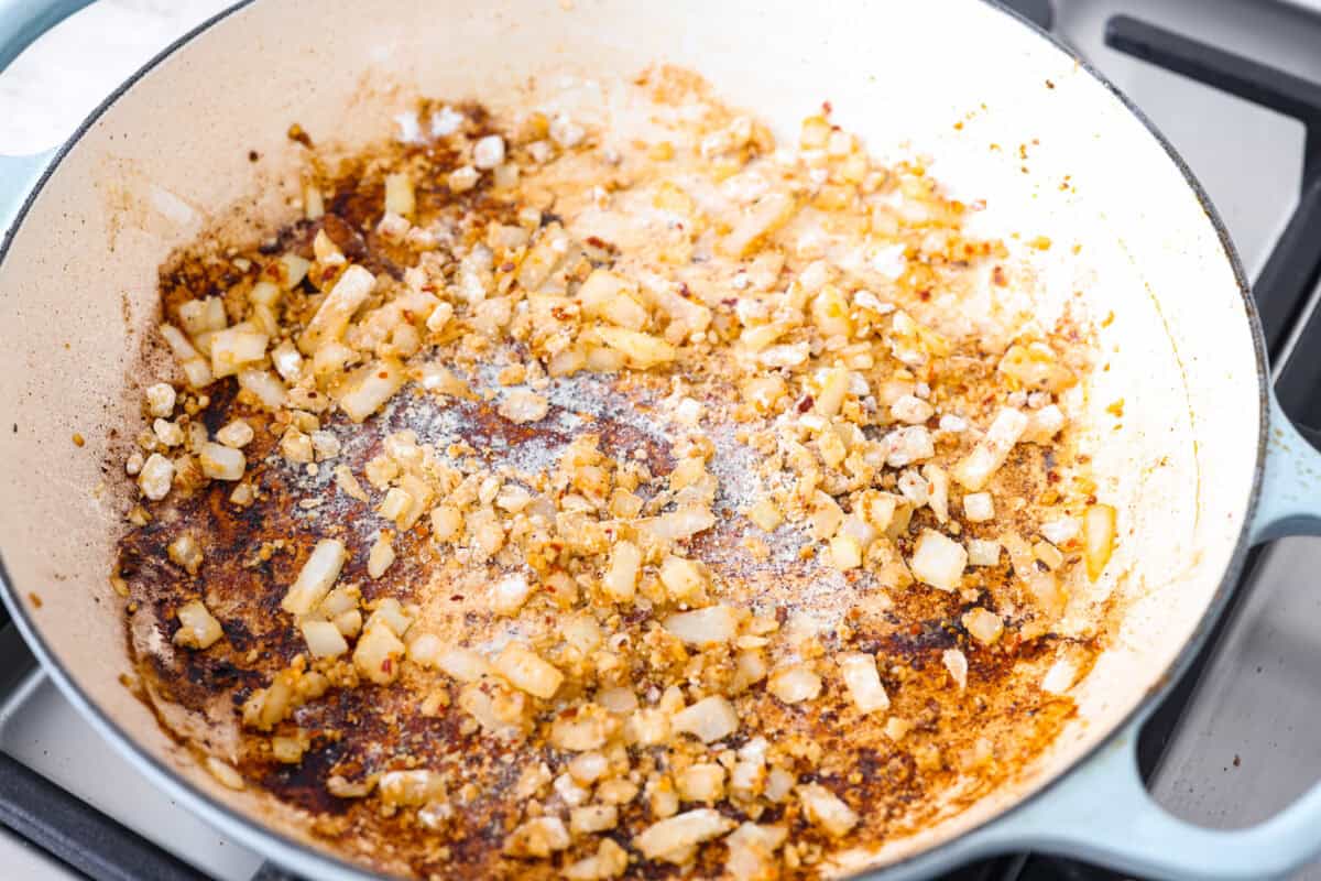 Creamy Cajun Chicken is the perfect combination of bold, zesty flavors and rich, velvety sauce. Juicy, tender chicken is coated in a perfectly spiced Cajun seasoning and simmered in a luscious, creamy sauce thatโs packed with flavor. Overhead shot of onions and garlic sautรฉing in the skillet.