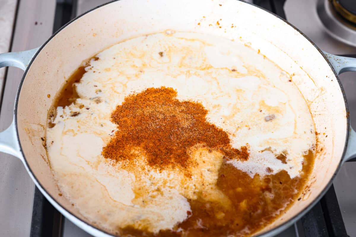 Creamy Cajun Chicken is the perfect combination of bold, zesty flavors and rich, velvety sauce. Juicy, tender chicken is coated in a perfectly spiced Cajun seasoning and simmered in a luscious, creamy sauce thatโs packed with flavor. Angle shot of cream, broth, cheese and seasonings added to the skillet.