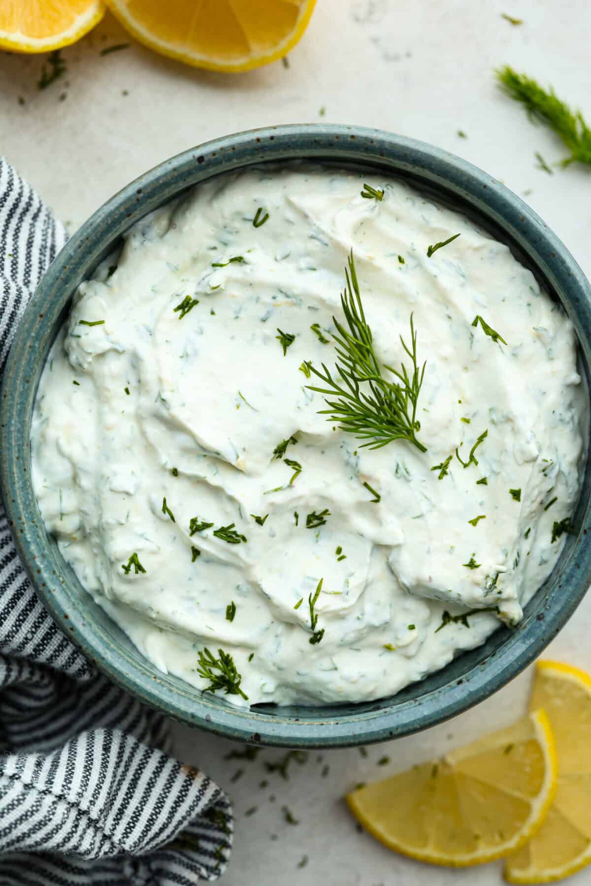 This creamy lemon dill sauce is fresh, tangy, and packed with flavor! Itโs the perfect complement to salmon, roasted veggies, or even as a dip for crispy potatoes. Made with simple ingredients like fresh dill, lemon, and a touch of garlic, it comes together in minutes! Overhead shot of a bowl of lemon dill sauce.