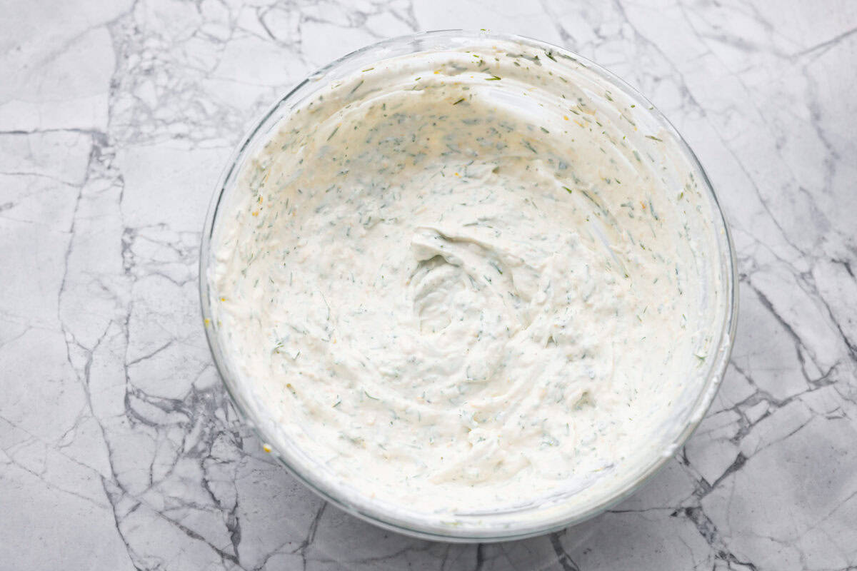 This creamy lemon dill sauce is fresh, tangy, and packed with flavor! Itโs the perfect complement to salmon, roasted veggies, or even as a dip for crispy potatoes. Made with simple ingredients like fresh dill, lemon, and a touch of garlic, it comes together in minutes! Overhead shot of all of the ingredients mixed together in a bowl.