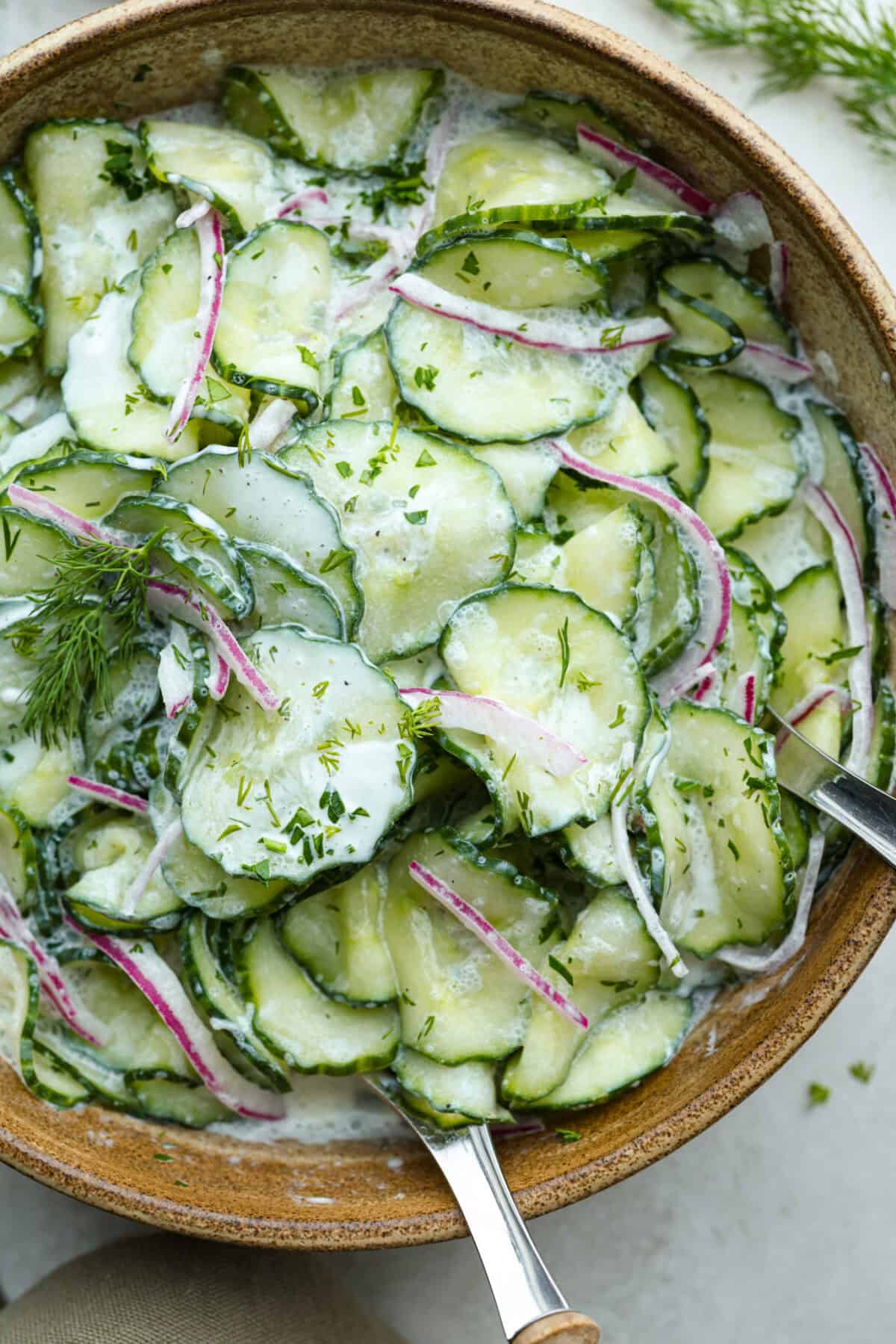 California rolls Close up shot of german cucumber salad in a serving bowl.