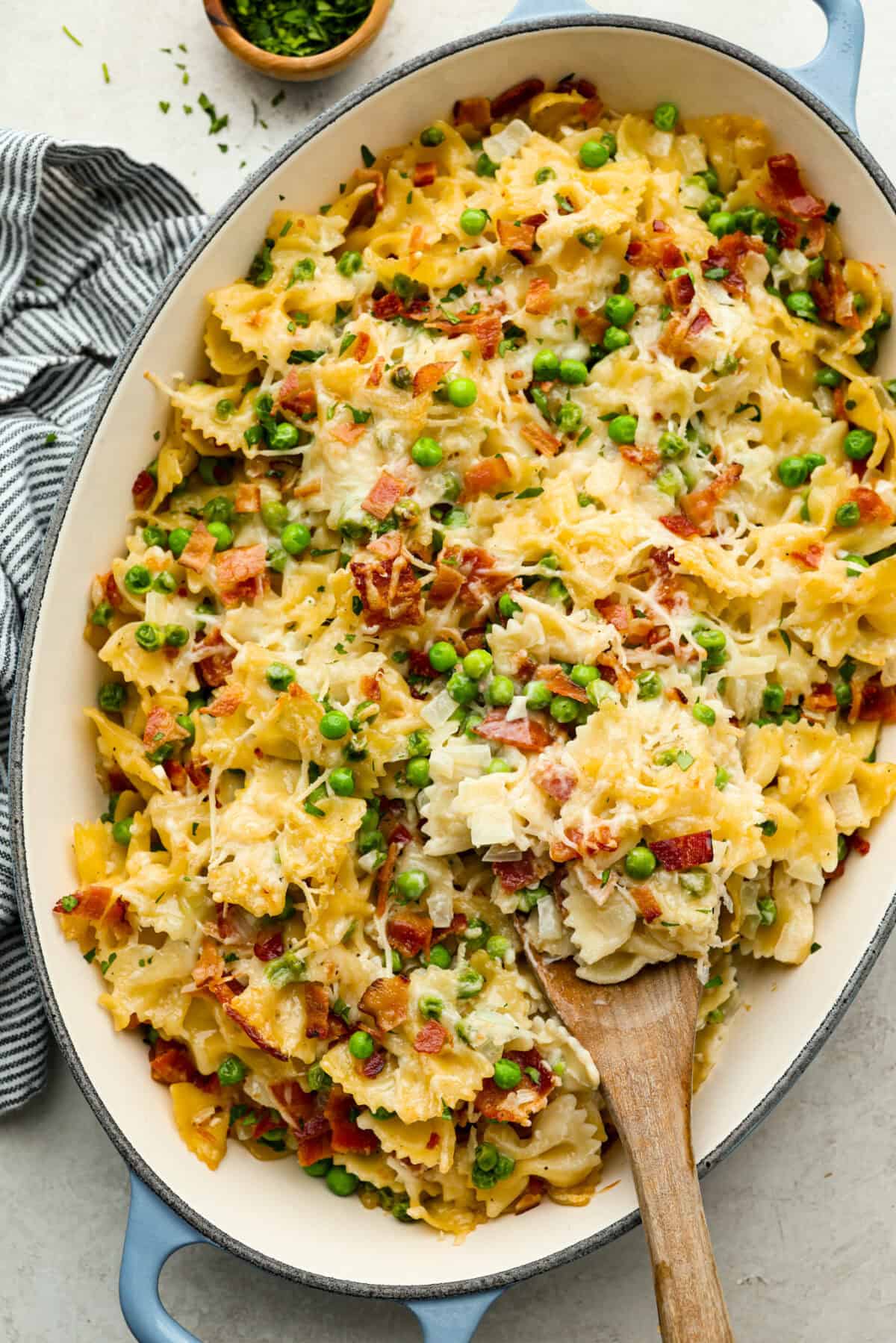 Stanley Tucci pasta casserole is everything you want in a casserole. It's simple to make and incredibly flavorful! TikTok is going crazy over the crispy bacon, tender peas, and the creamy, cheesy sauce that holds everything together! Overhead shot of baked Stanley Tucci pasta casserole.