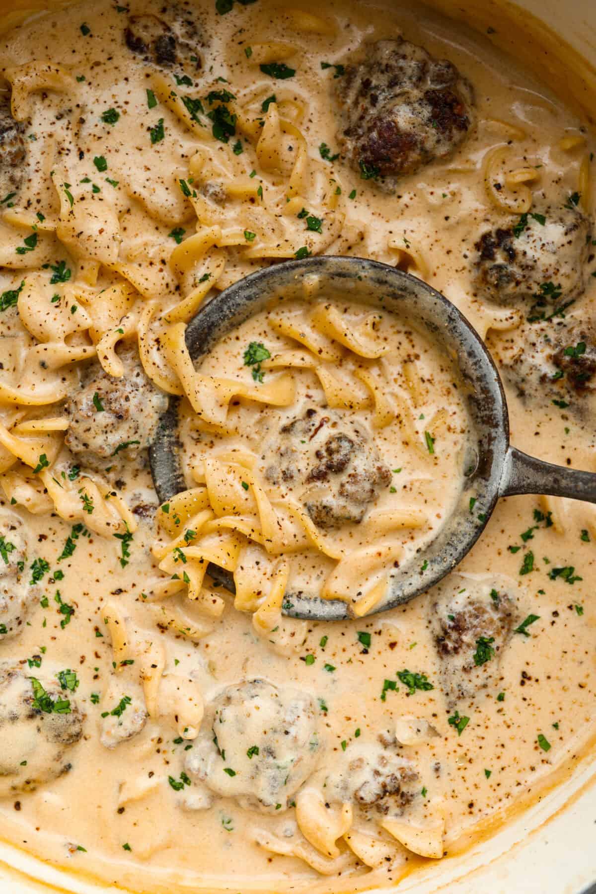 Warm and comforting, this cozy Swedish meatball soup is the perfect meal for chilly days. Juicy meatballs simmer in a rich, savory broth with tender noodles, making every spoonful satisfying. It’s easy to make and sure to become a family favorite! Close up shot of Swedish meatball soup.
