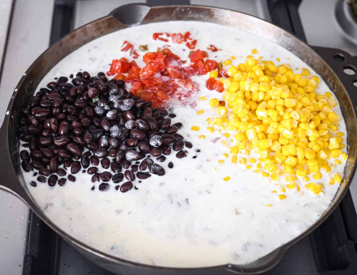Creamy, cheesy Cowboy Mac and Cheese gets a bold twist with hearty additions like seasoned meat, tomatoes, jalapeรฑos, corn, beans, and onions. It's rich, flavorful, and just the right amount of spice! The heat is warm but not overwhelming. If you like it spicy, add more jalapeรฑos! Whole milk, black beans, corn and canned tomatoes with green chilies added to the skillet.