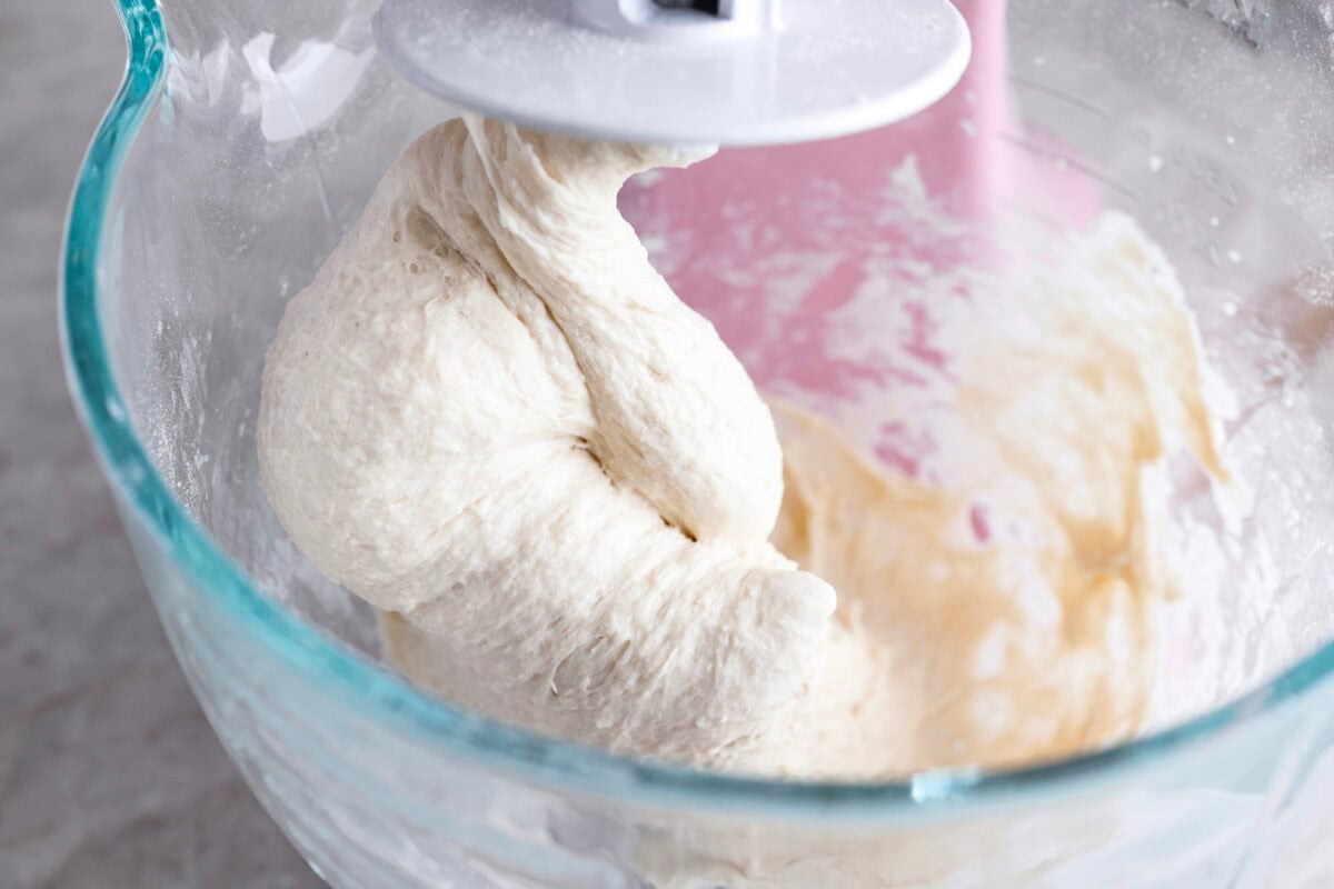 Pizza Hut breadsticks are warm, fluffy, and buttery, but this copycat recipe is even better! Coated in seasoning, parmesan, and melted butter, theyโre next-level delicious. Dough being mixed with a stand mixer.