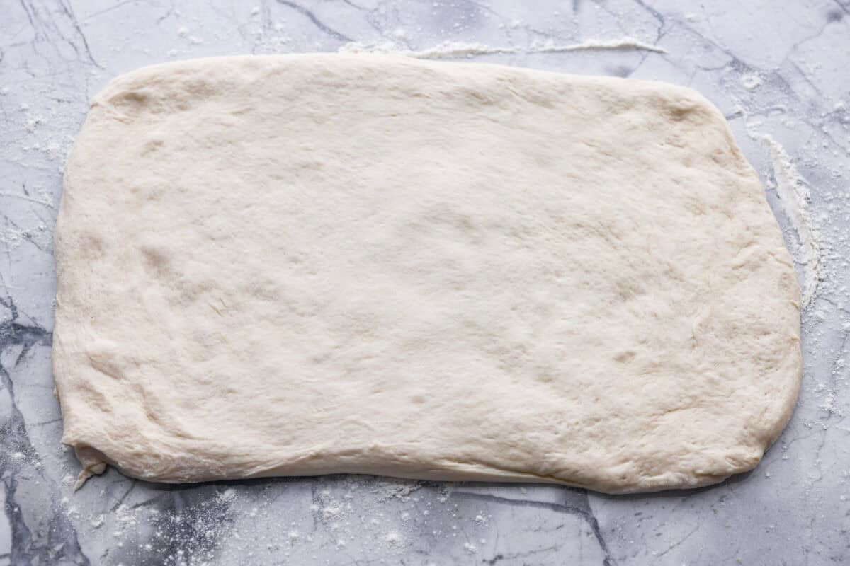 Pizza Hut breadsticks are warm, fluffy, and buttery, but this copycat recipe is even better! Coated in seasoning, parmesan, and melted butter, theyโre next-level delicious. Breadstick dough rolled out onto a floured surface.