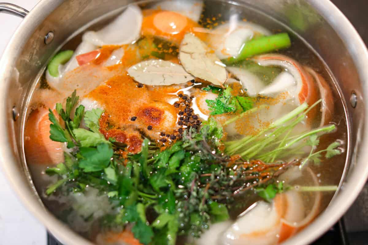 Homemade vegetable broth is light, delicate, and infused with the flavor of fresh vegetables. It's incredibly easy to make and great for using leftover veggies. The key is to not overcook the veggies. This can lead to a bitter flavored broth. Herbs and spices added to the pot of water and veggies.