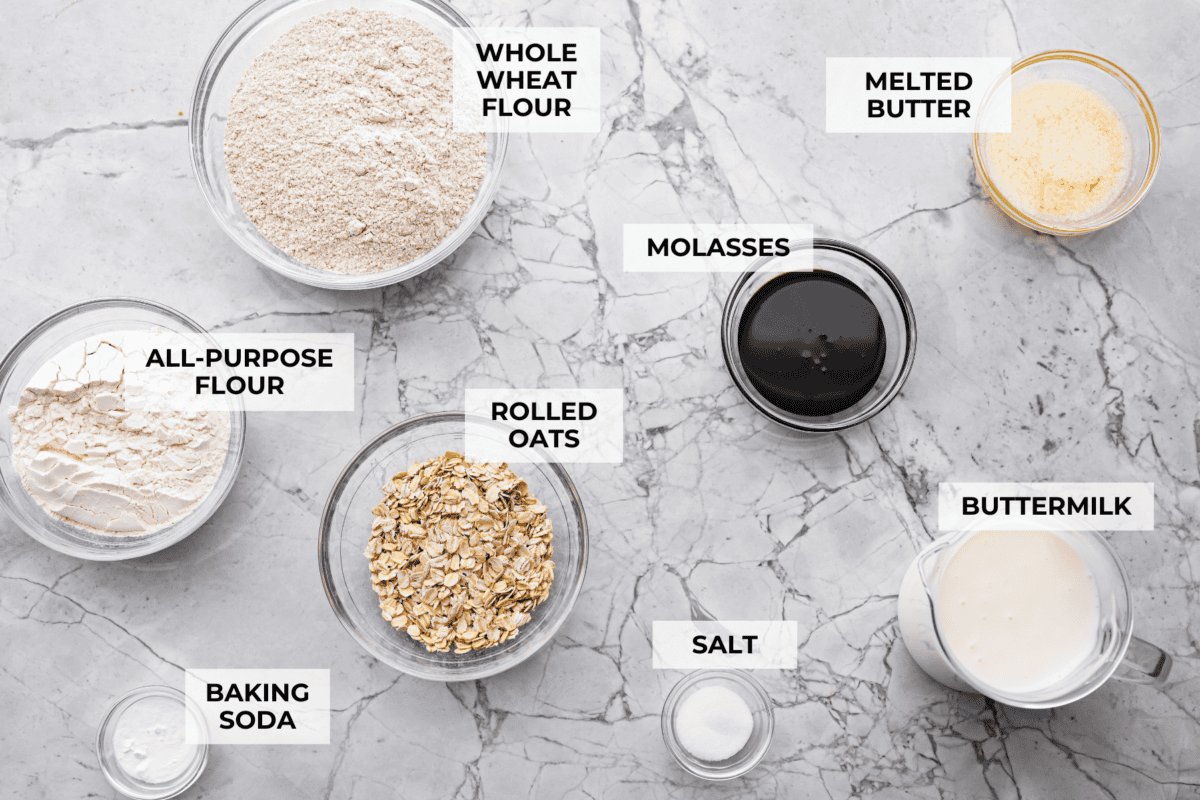 Irish Brown Bread is a delicious twist on classic soda bread, offering a slightly sweet, rich, and hearty flavor. It comes together quickly and makes a great breakfast, snack, or side with dinner. It's so yummy with honey, butter, or jam! Overhead shot of labeled ingredients.