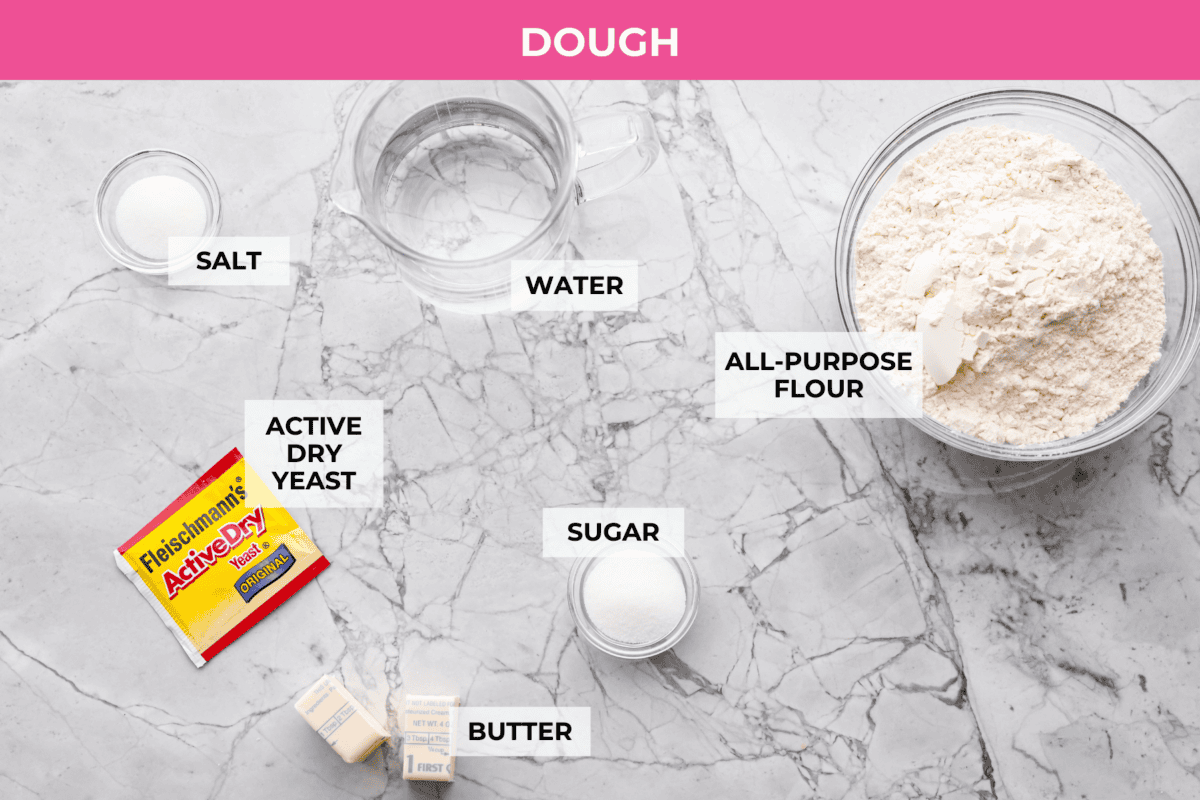 Youโll love these copycat Pizza Hut breadsticks with a fluffy, soft inside and crispy, buttery outside, all topped with delicious seasoning, Parmesan, and melted butter! Overhead shot of labeled pizza hut breadsticks dough ingredients.