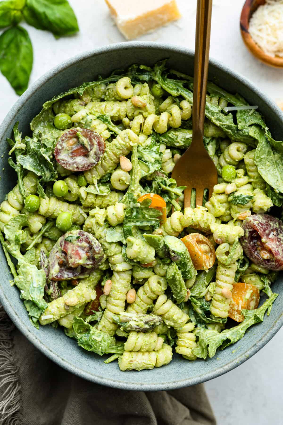 This Green Goddess Pasta Salad is fresh, vibrant, and full of flavor! The creamy herb dressing adds a tangy twist, while crisp spring veggies make it light yet hearty. Perfect for potlucks or any time youโre craving a delicious side! Overhead shot of a bowl of green goddess pasta salad.