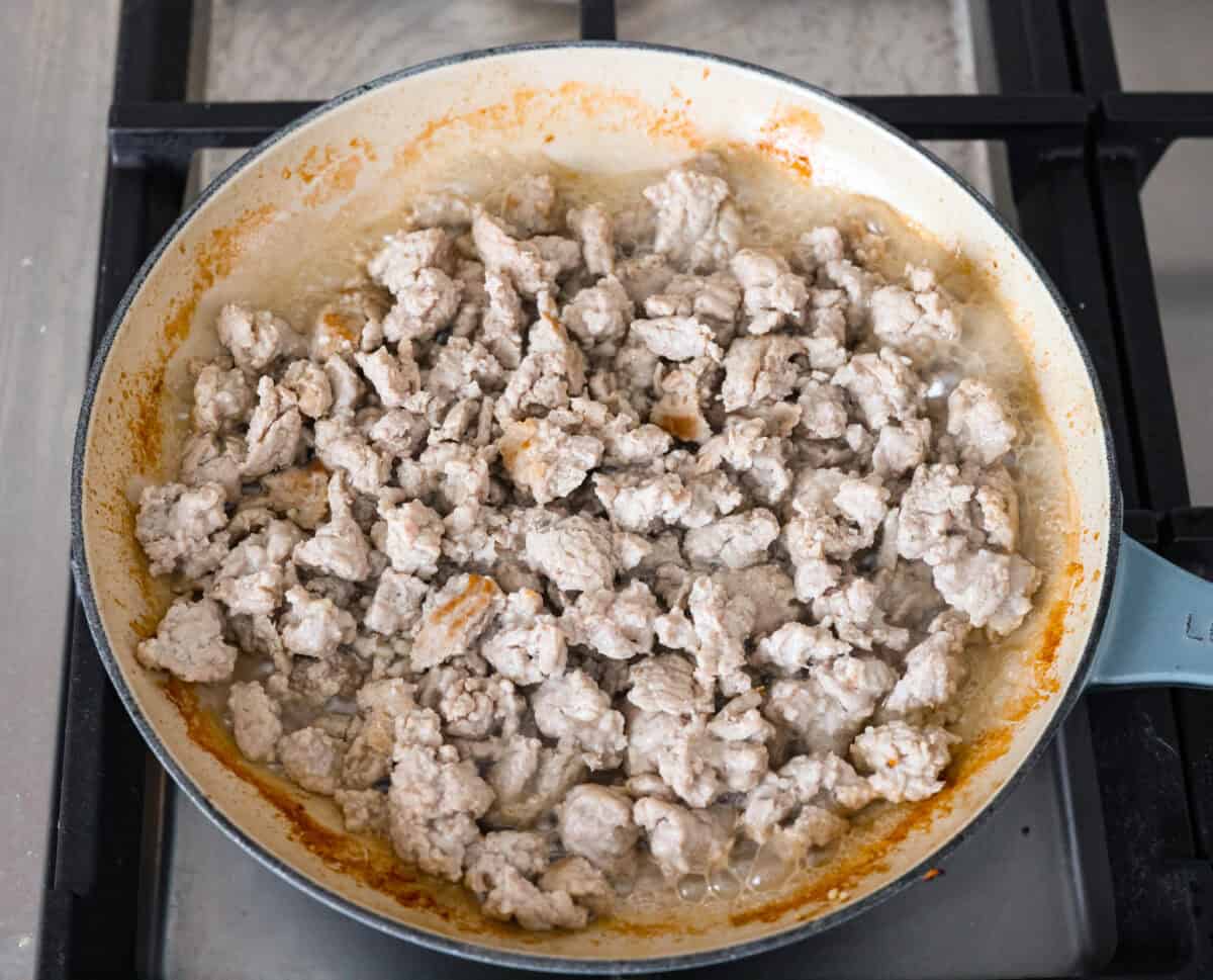 These ground turkey tacos are full of fiesta flavor, all with less fat! Don't let ground turkey steer you away! No one will miss the beef once they taste this taco filling. The seasonings and flavors absorb perfectly into the meat. Overhead shot of ground turkey cooking in a skillet.