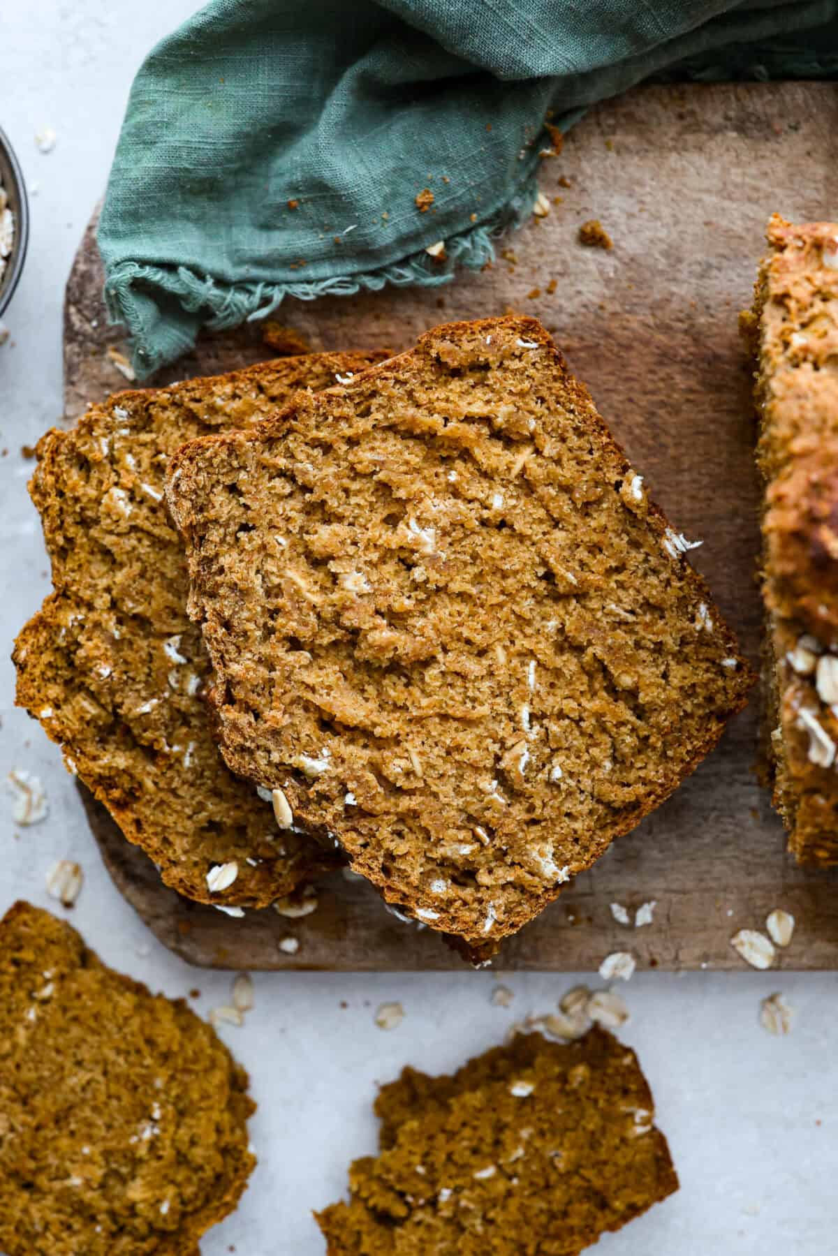 Irish Brown Bread is a delicious twist on classic soda bread, offering a slightly sweet, rich, and hearty flavor. It comes together quickly and makes a great breakfast, snack, or side with dinner. It's so yummy with honey, butter, or jam! Overhead shot of sliced Irish brown bread on a cutting board.