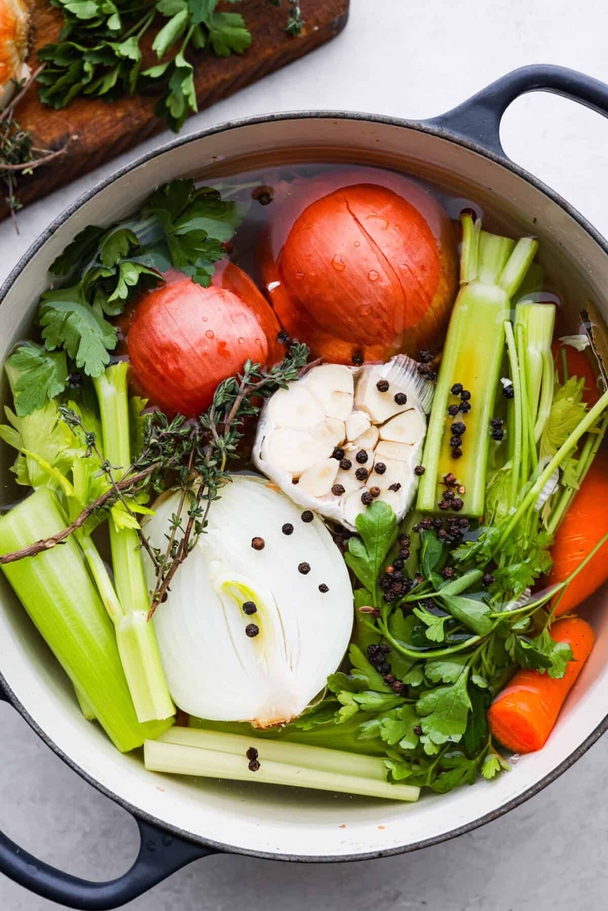 Overhead shot of all of the vegetables in a large stock pot ready to be turned into homemade vegetable broth. 
