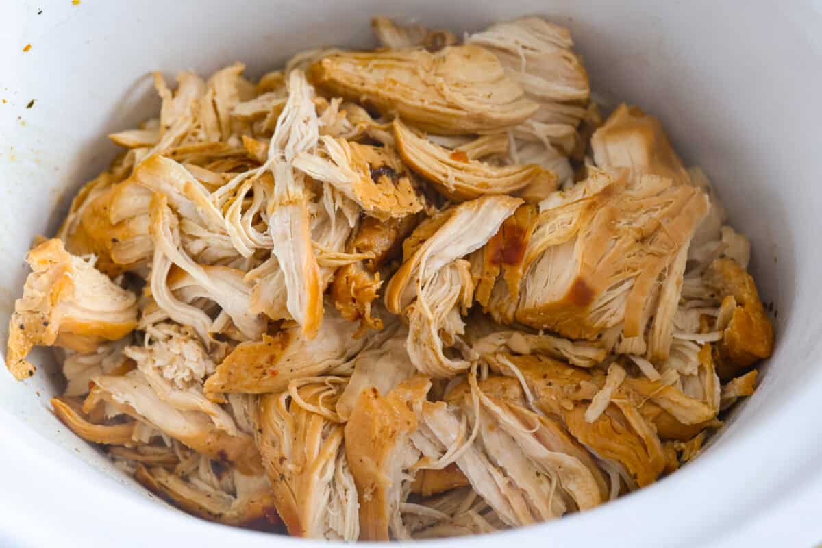 You guys can't get enough of my 3 packet roast, so it's time for a new version, 3 Packet Crockpot Chicken! It takes just 5 minutes to prep and comes out juicy, tender, and full of flavor. 3 packet chicken shredded in the bottom of the crockpot.