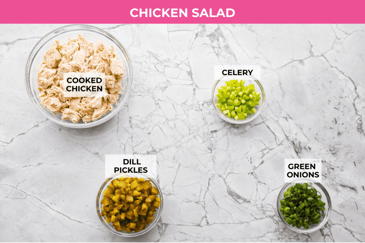 If you love that good pickle crunch, this high-protein Dill Pickle Chicken Salad is a must! It’s bold, zesty, and perfect for sandwiches or a snack right out of the bowl! Overhead shot of labeled chicken salad ingredients.