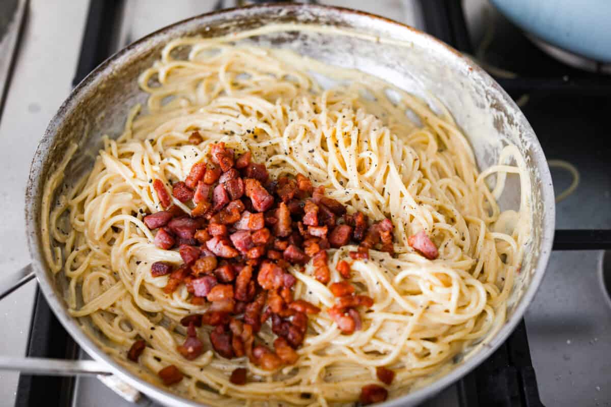 You guys! My pasta carbonara is the real deal—creamy, dreamy, and so full of flavor! Just eggs, cheese, pancetta, and pasta magic. It feels restaurant worthy but takes less than 30 minutes! Cooked pancetta over the pasta carbonara.