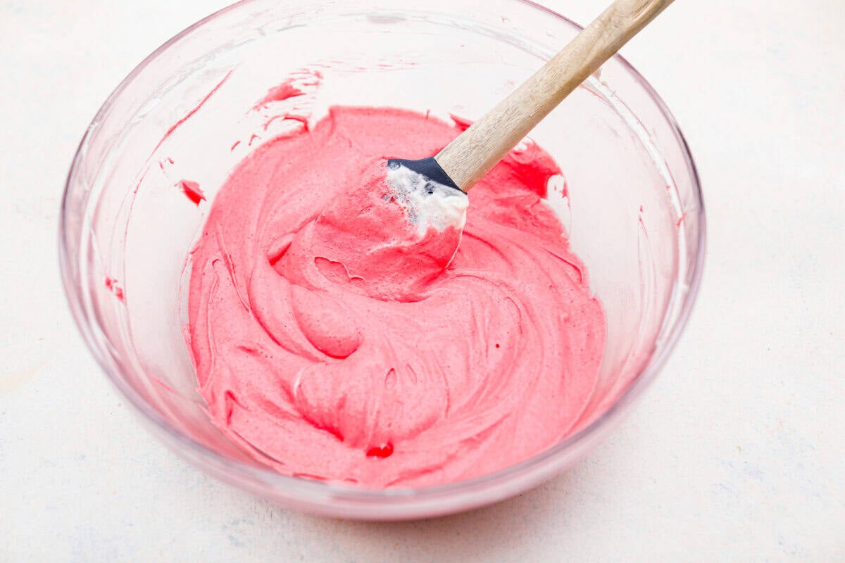 My Strawberry Delight is the ultimate summer showstopper! Buttery crust, juicy strawberries, sweet jello, and fluffy toppingโone bite and everyoneโs hooked. Strawberry jello layer ingredients mixed together in a bowl.