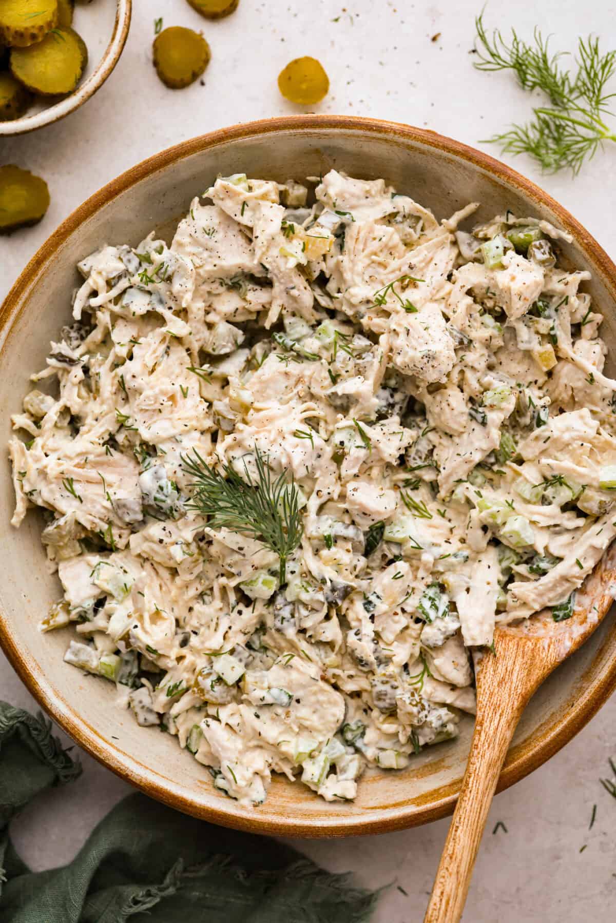 If you love that good pickle crunch, this high-protein Dill Pickle Chicken Salad is a must! It’s bold, zesty, and perfect for sandwiches or a snack right out of the bowl! Serving bowl filled with dill pickle chicken salad.