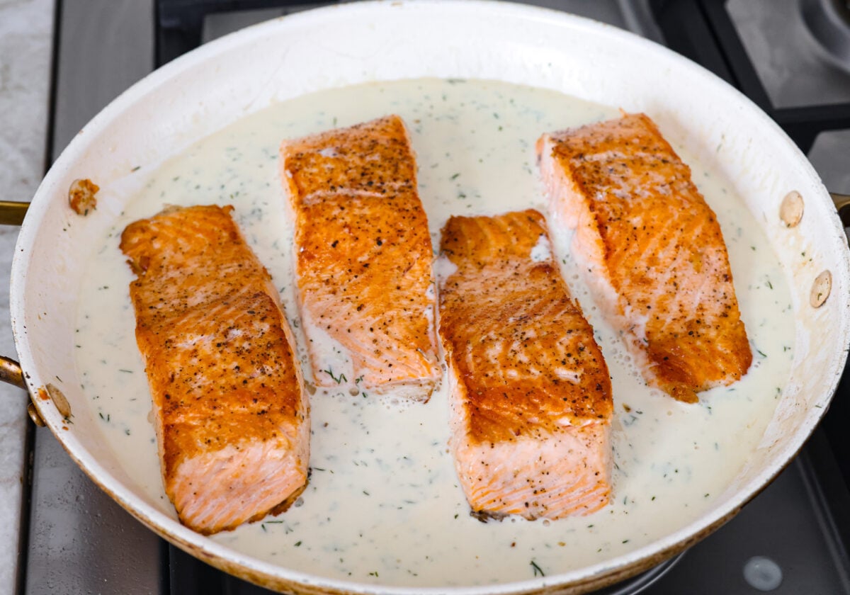 My Pan Seared Salmon has a new and improved Sauce! I added salt to bring out the flavors, and now it’s perfect! Fresh lemon juice and dill make it a match made in salmon heaven! Salmon added back to the pan with the sauce.