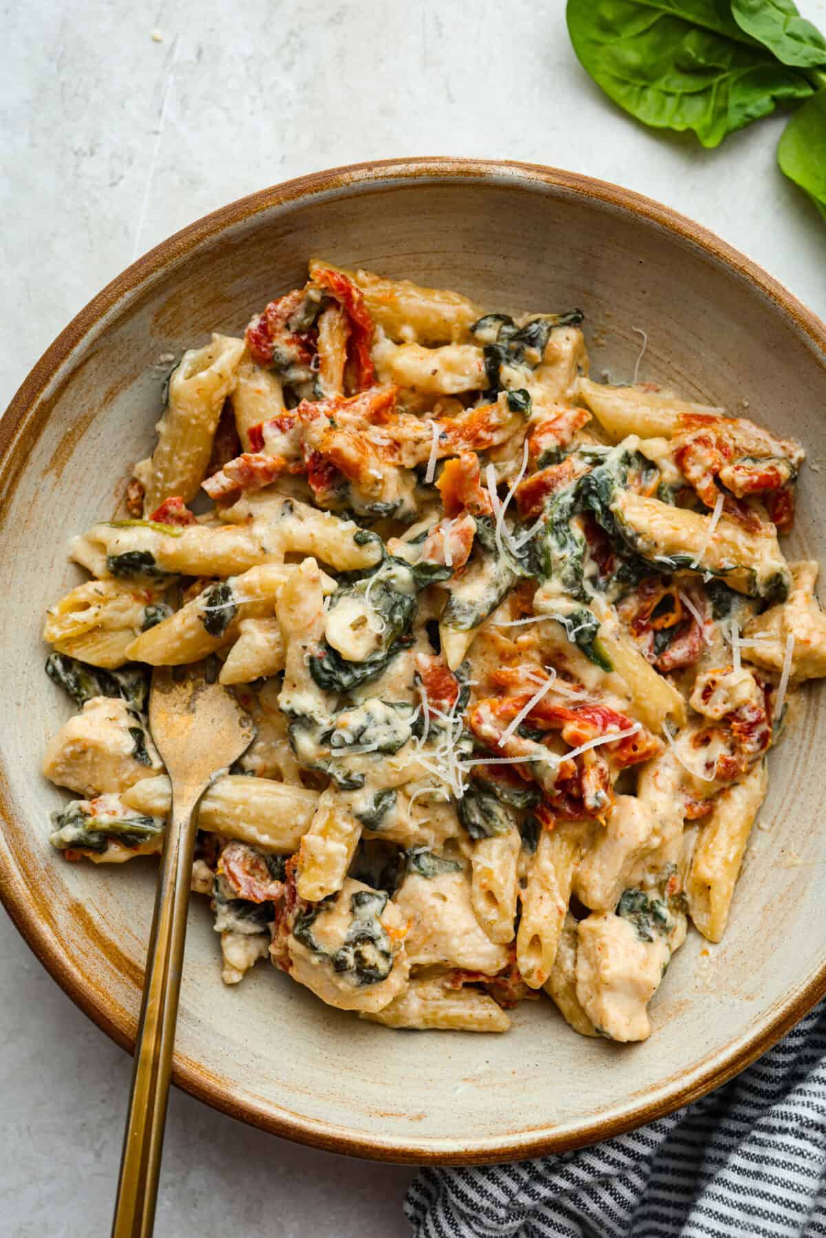 You all love my Crockpot Tuscan Chicken, and I know casseroles are a favorite as well. So, I combined them into this irresistibly delicious Tuscan Chicken Casserole! Plated tuscan chicken casserole.