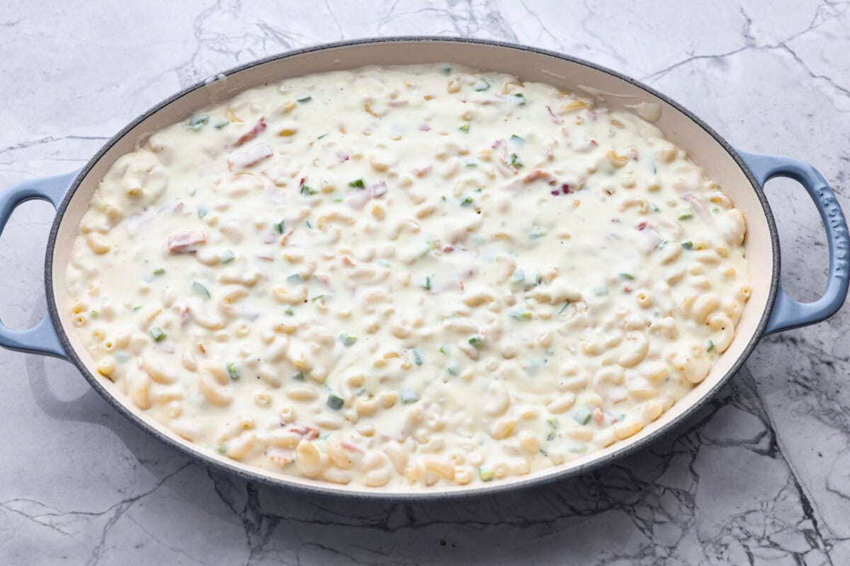 You guys, this Jalapeño Popper Mac and Cheese is downright sinful in the best way. Creamy, cheesy, spicy, and loaded with comfort food goodness! It’s easy to put together, and trust me, it’s so worth it! All of the mac and cheese ingredients added to a large baking dish.
