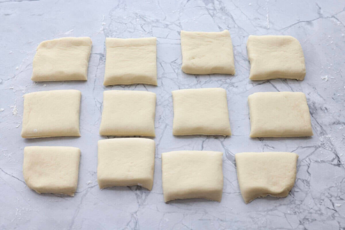 I am obsessed with Texas Roadhouse rollsโlike, zero self-control as soon as they hit the table. So, of course, I had to recreate them at home! These copycat Texas Roadhouse rolls are soft, fluffy, slightly sweet, and melt-in-your-mouth good. Texas Roadhouse roll dough cut into squares.