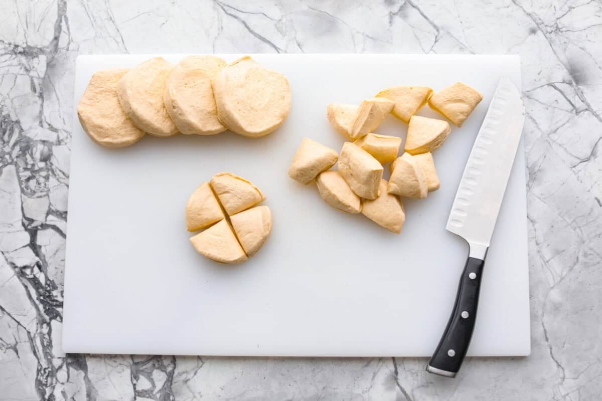Bubble Pizza is what you make when you want something cozy, cheesy, and easy. Think pizza meets pull-apart bread with zero rolling, stretching, or takeout guilt. Canned biscuits out on a cutting board with a knife.