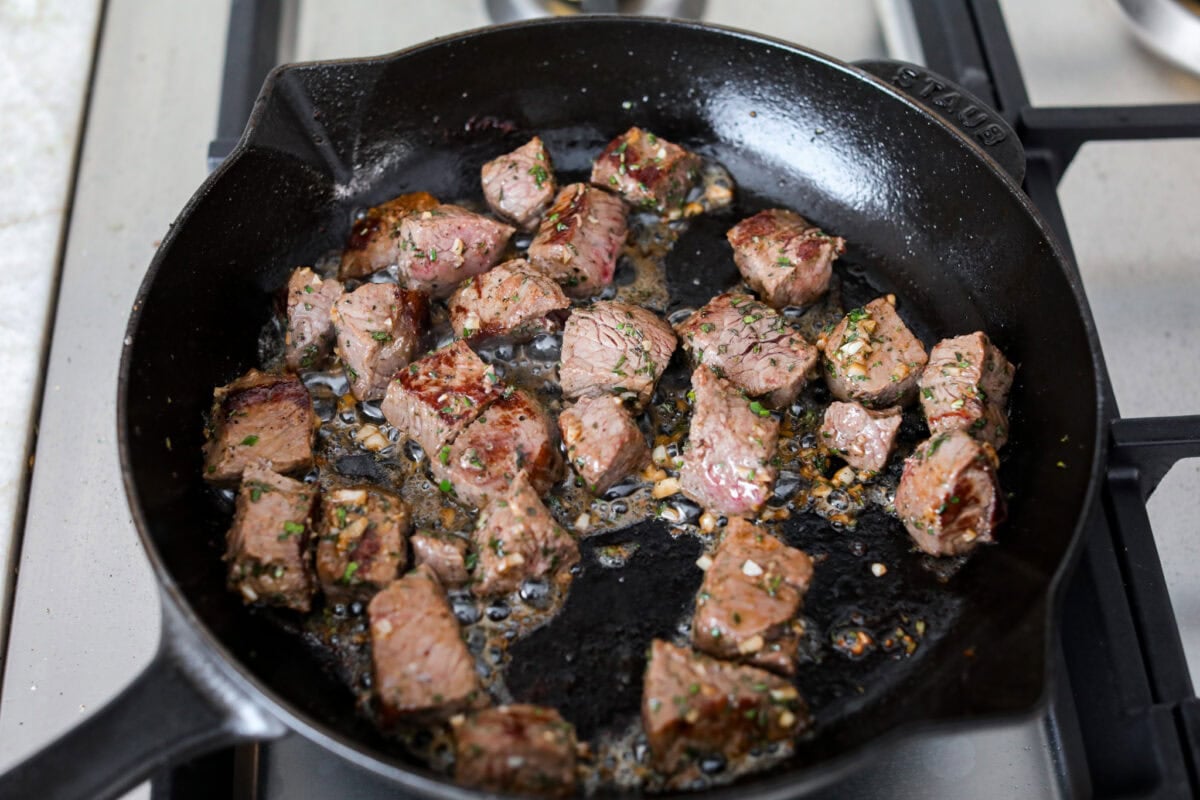 Get ready to obsess! These Garlic Butter Herb Steak Bites with Potatoes are juicy, buttery, and downright irresistible. Easy to make, crazy delicious, and pure comfort in every bite! Seared steak pieces with garlic and herbs added.