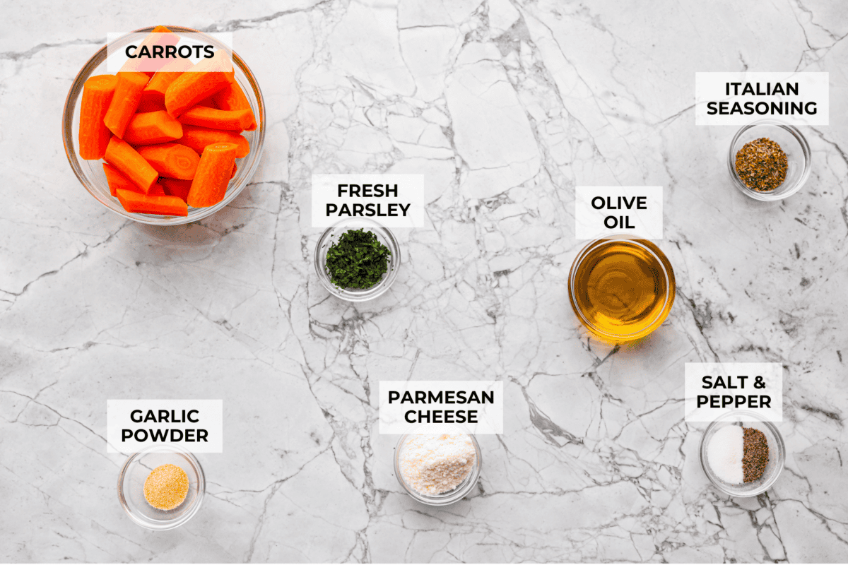 If there’s one side dish that never sticks around for long at my house, it’s these air fryer carrots! They’re crisp on the outside, tender inside, and seasoned to bring out all their natural sweetness—even the picky eaters love them! A top down shot of all of the ingredients labeled and in individual bowls.