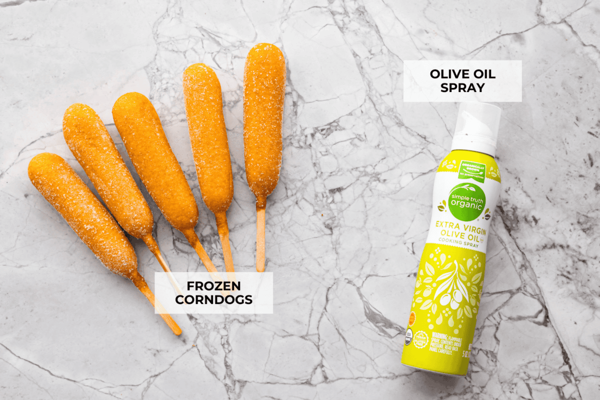 Air fryer corn dogs bring fair-style crunch without the extra oil! Crispy outside, juicy inside, and ready in minutes—perfect for a quick snack or easy meal! Overhead shot of labeled ingredients.