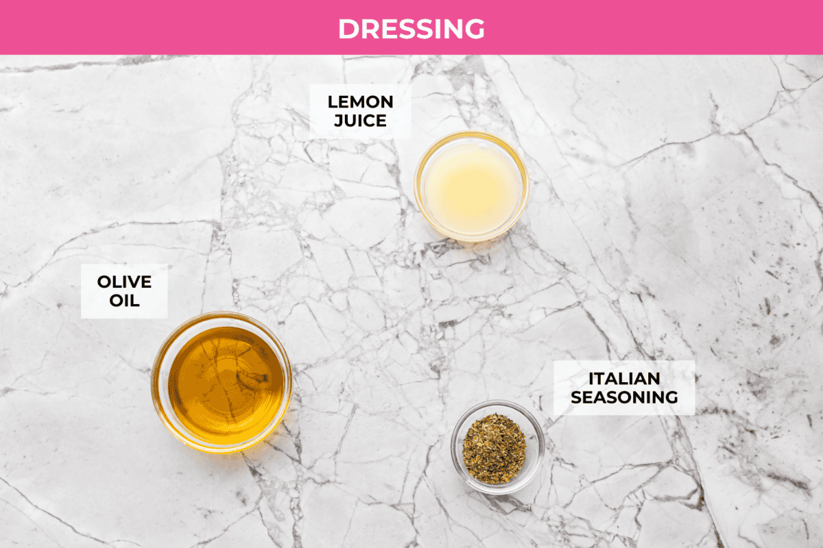 Okay, this antipasto salad? Itโs basically an Italian snack board in a bowl, and Iโmย obsessed! What makes this one a little different (and so good) is the easy lemony dressing. Overhead shot of labeled dressing ingredients.