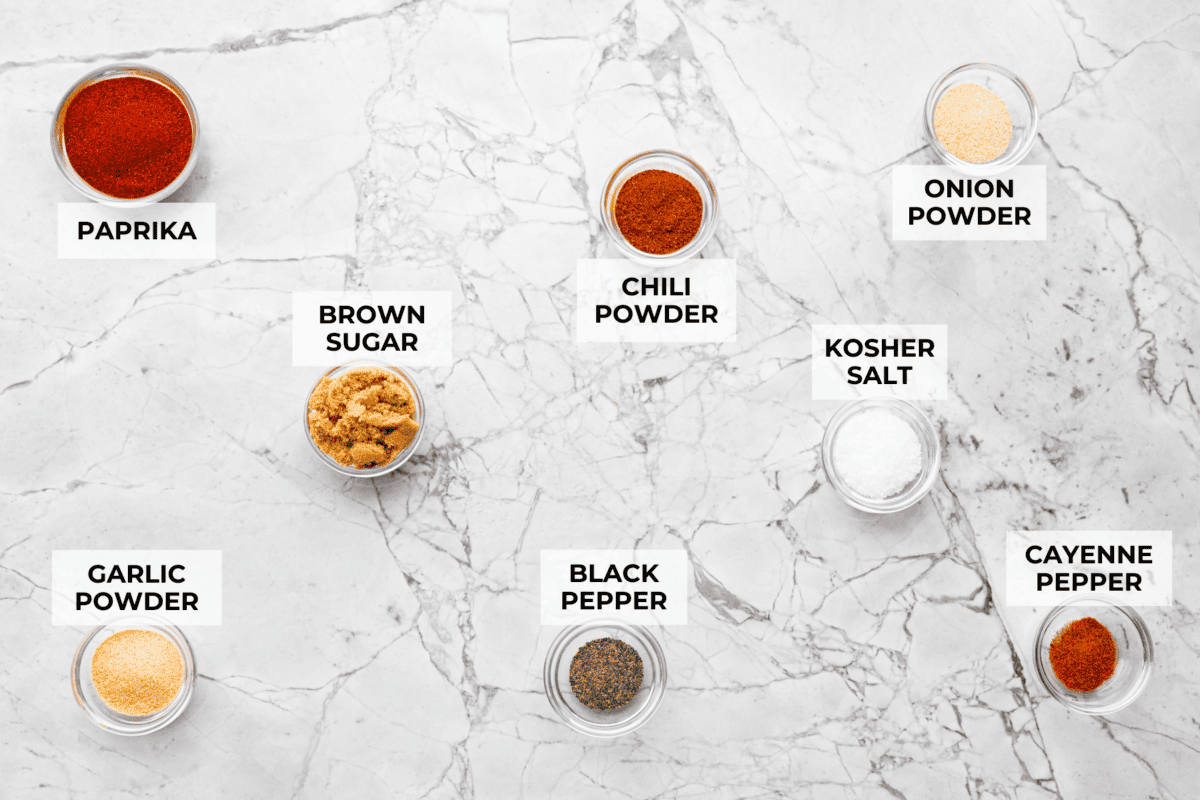 My homemade BBQ seasoning brings bold, smoky flavor to just about anything! Itโs the perfect blend of sweet, savory, and just a little kick, ready to shake onto chicken, veggies, ribs, and more. Overhead shot of labeled ingredients.