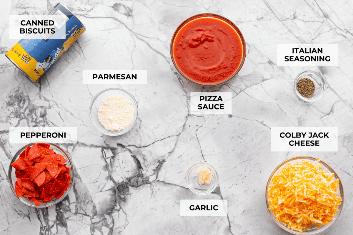Bubble Pizza is what you make when you want something cozy, cheesy, and easy. Think pizza meets pull-apart bread with zero rolling, stretching, or takeout guilt. Overhead shot of labeled ingredients.