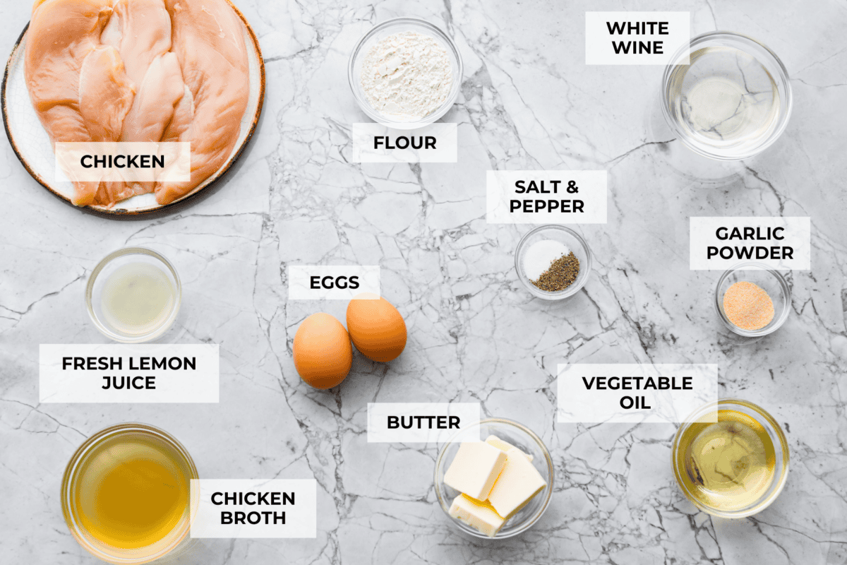 If youโve never had Chicken Francese, youโre in for a treat! Lightly breaded chicken, pan-fried to golden perfection, then bathed in a bright, buttery lemon sauce thatโs totally irresistible. Overhead shot of labeled chicken Francese ingredients.