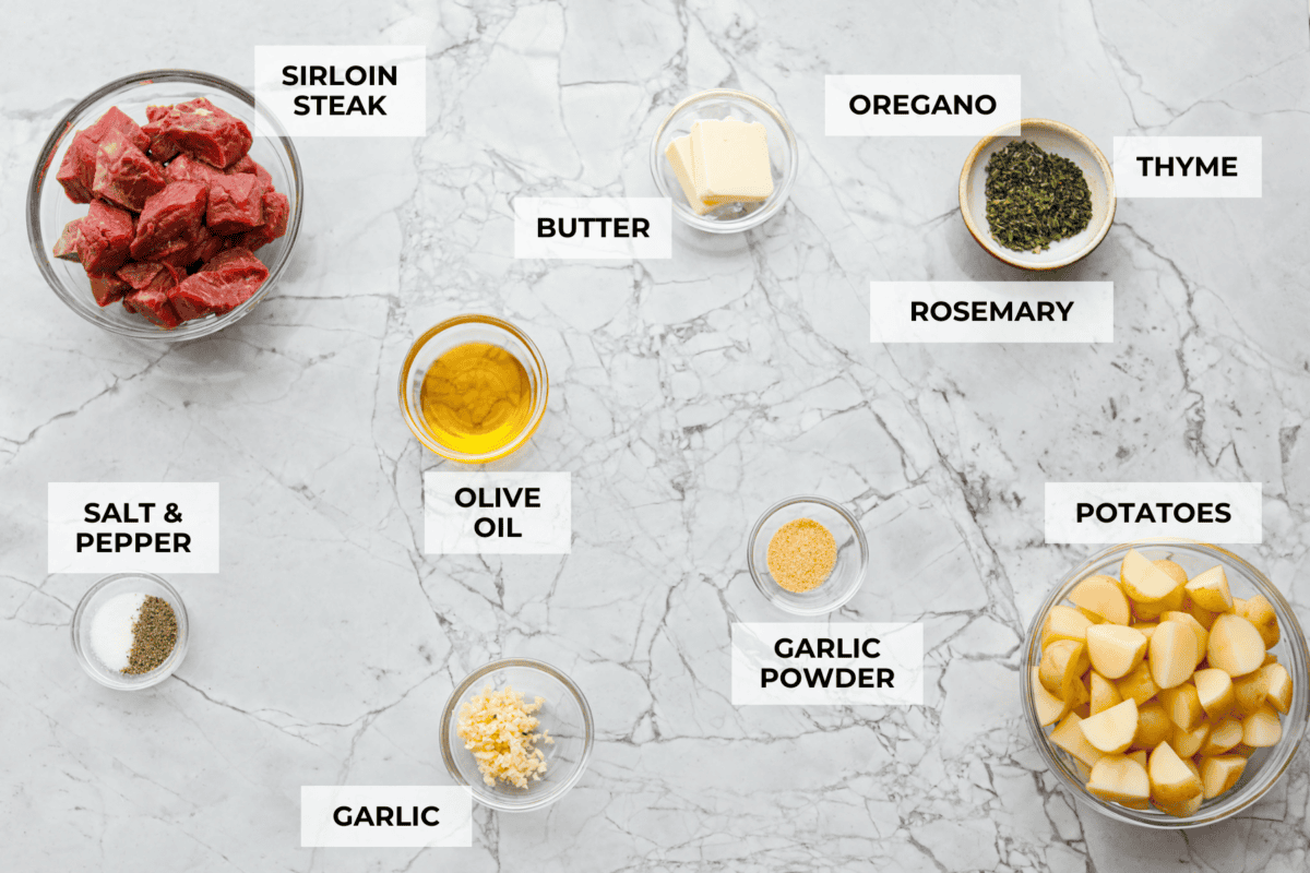 Get ready to obsess! These Garlic Butter Herb Steak Bites with Potatoes are juicy, buttery, and downright irresistible. Easy to make, crazy delicious, and pure comfort in every bite! Overhead shot of labeled ingredients.