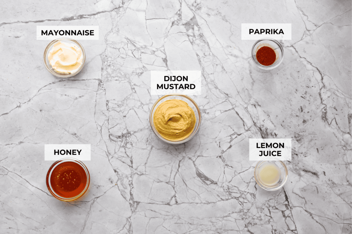 My all-time favorite sauce! This Honey Mustard is so addictive, youโll be drizzling it on everything! And the best part? It only takes 5 minutes with ingredients you probably already have in your kitchen. Overhead shot of labeled ingredients.