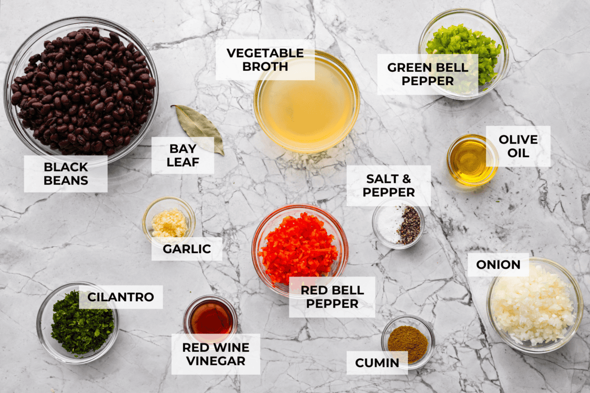 For these Cuban Black Beans, I used canned black beans to save time on soaking and cooking, so you can enjoy that rich, homemade flavor in a fraction of the time! Overhead shot of labeled ingredients for Cuban black beans.